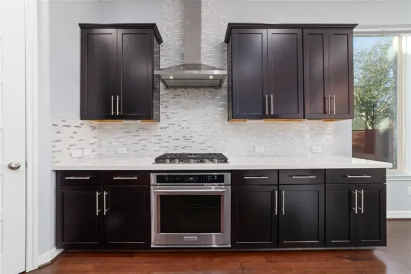 a kitchen with granite countertop wooden cabinets and stainless steel appliances