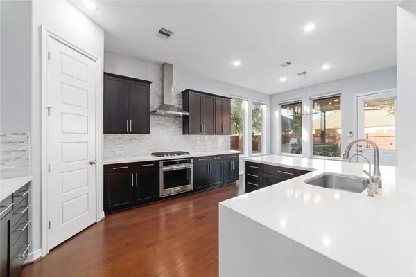 a kitchen with stainless steel appliances granite countertop a sink stove and refrigerator