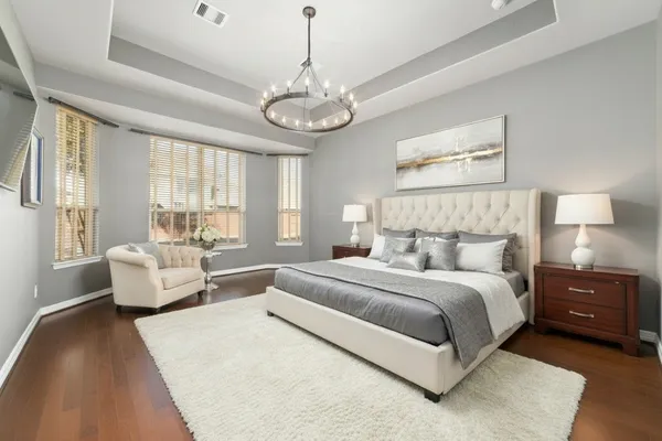 a spacious bedroom with a bed and couch