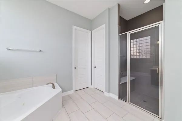a bathroom with a bathtub and a shower