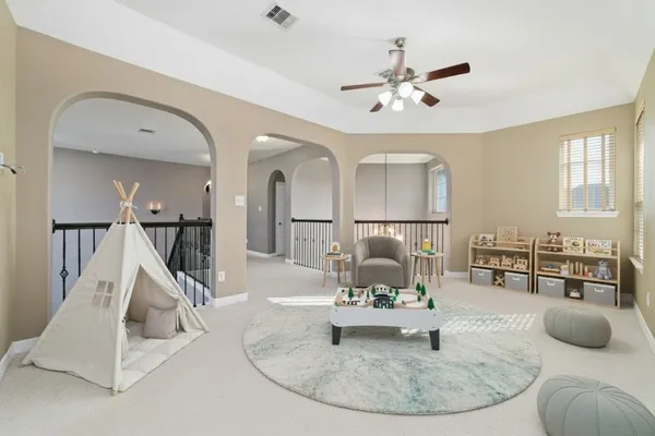 a living room with furniture and kitchen view
