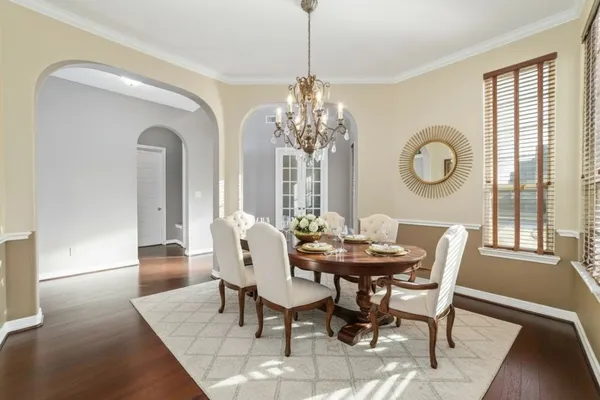 a view of a dining room with furniture and chandelier