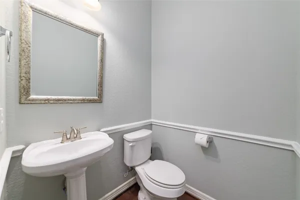 a white toilet sitting next to a bathroom sink