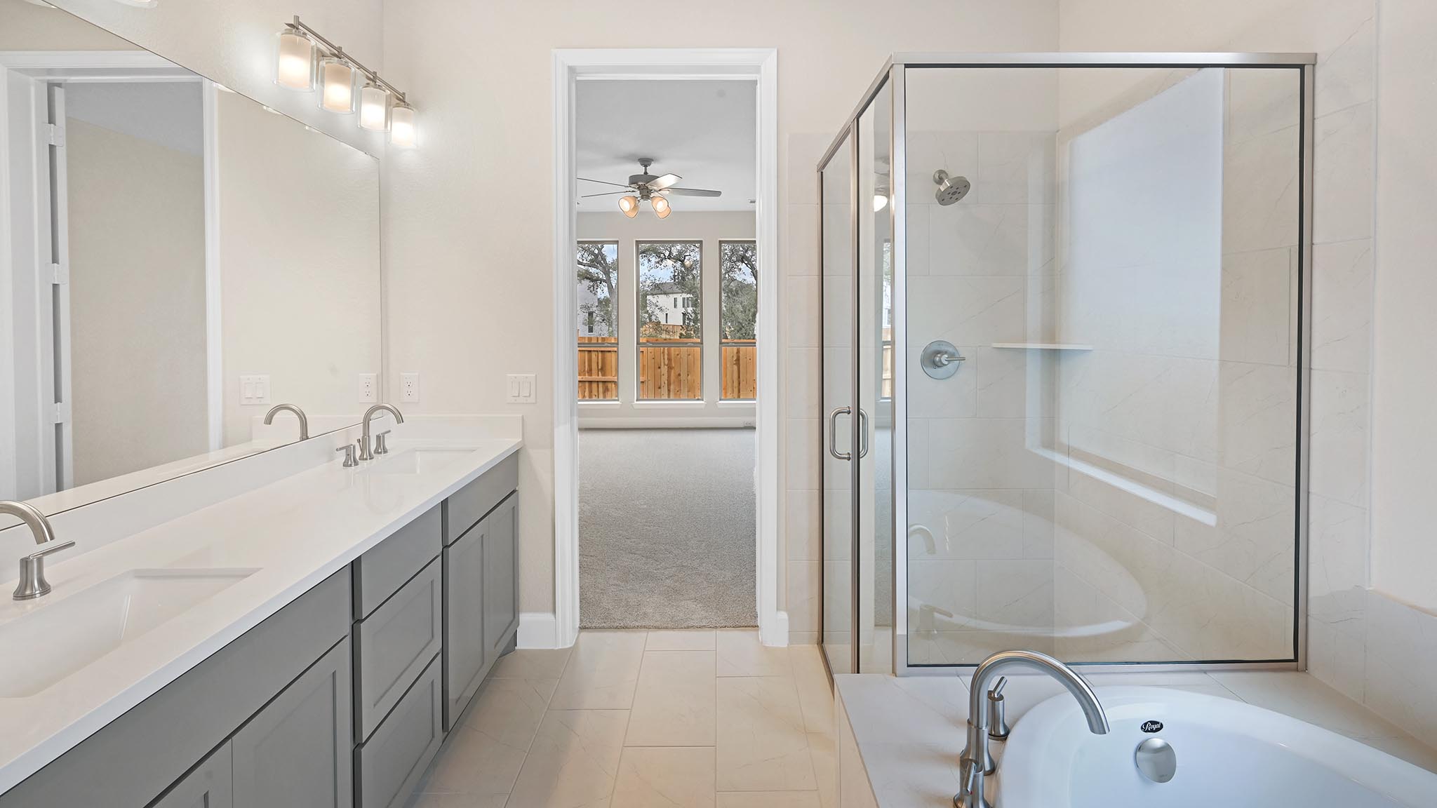 338 Prickly Poppy Loop Kyle, TX 78640 - Photo 19 of 40 Full bathroom with double vanity, a stall shower, light tile patterned flooring, a bath, and light carpet