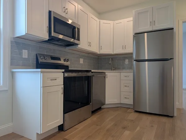 a kitchen with stainless steel appliances a refrigerator stove and microwave