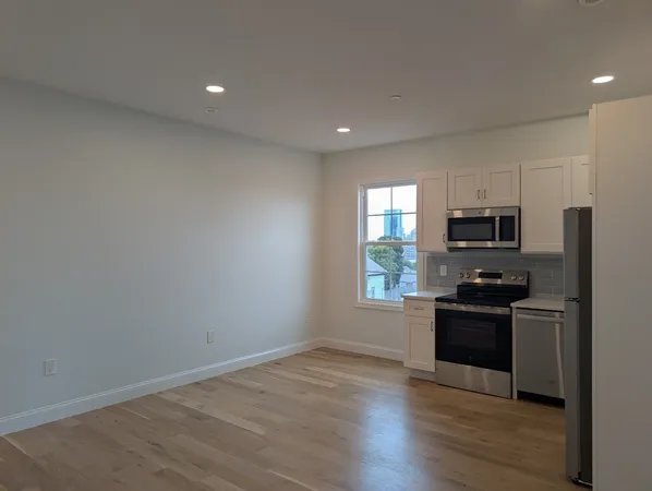 a kitchen with granite countertop a stove top oven and sink