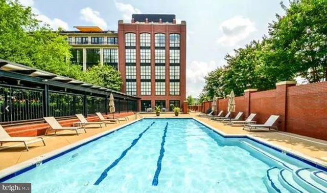 a view of swimming pool with chairs and tables