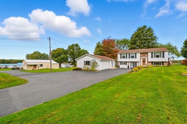 19 Yankee Ridge Road Mercer, PA 16137 - Photo 5 of 42 a yellow and red house with a yard
