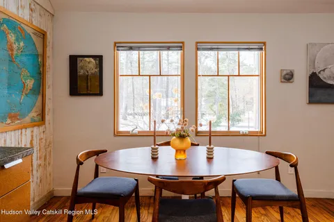a view of a dining room with furniture and window