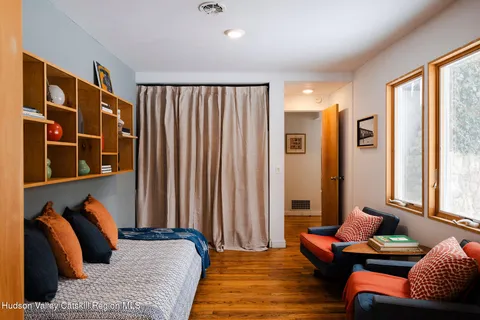 a bedroom with furniture and a large window