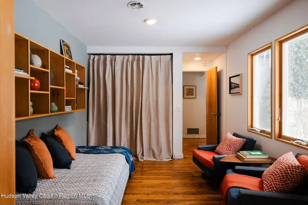 a bedroom with furniture and a large window