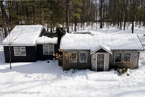 a view of a house with snow in the yard