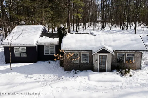 a view of a house with snow in the yard
