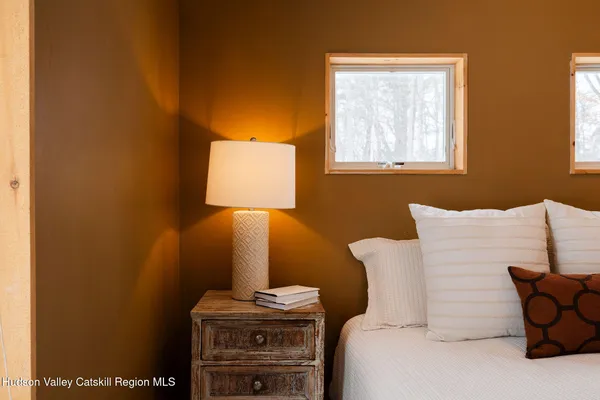 a bed room with a bed and a lamp