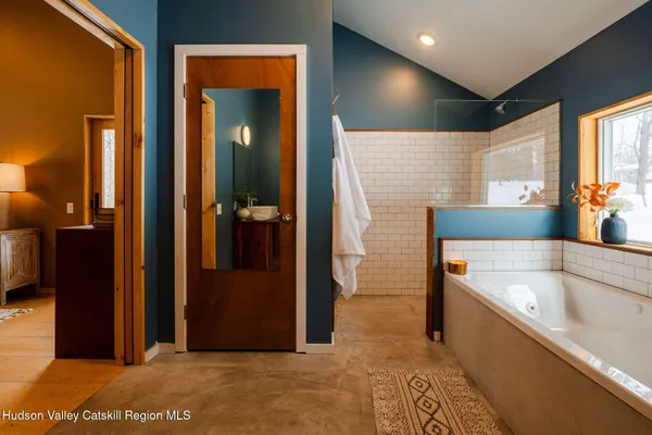 a bathroom with a bathtub and a shower