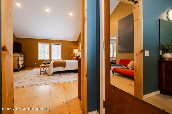 a en suite bathroom with a tub and view of bedroom