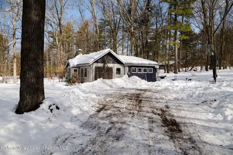 a view of house with a yard covered in snow
