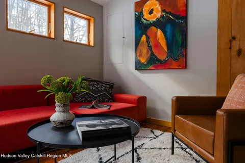 a living room with furniture and flowers