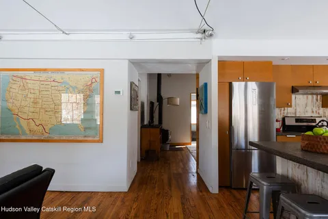 a view of a living room with furniture and wooden floor