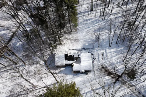 a view of a backyard with lawn chairs and couches