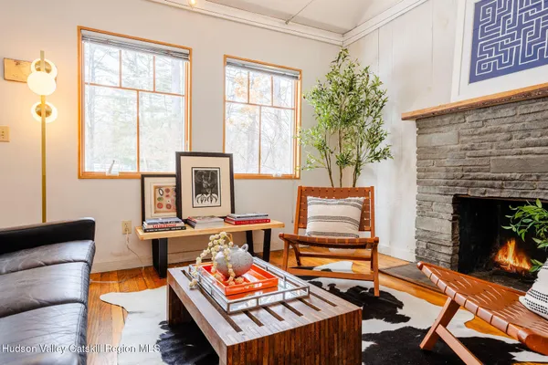 a living room with furniture a fireplace and next to a window