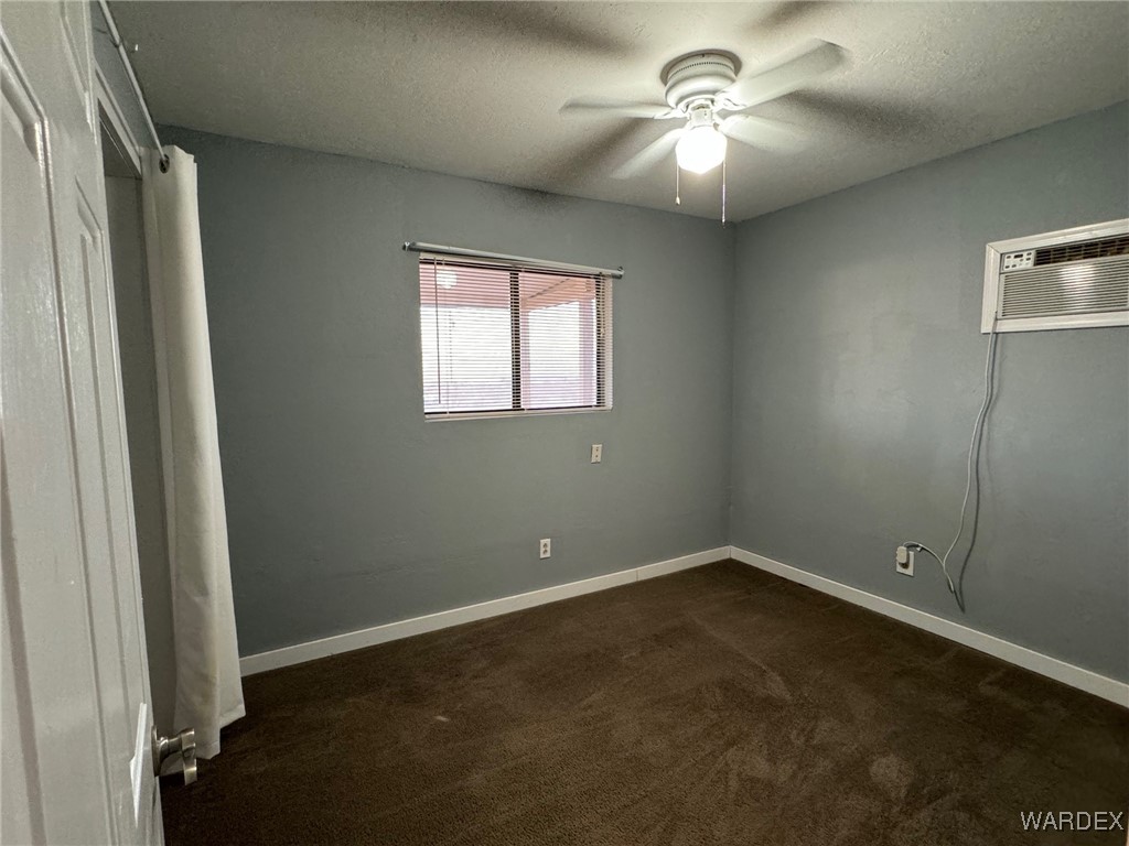 2661 Papago Road Golden Valley, AZ 86413 - Photo 29 of 30 an empty room with windows and fan