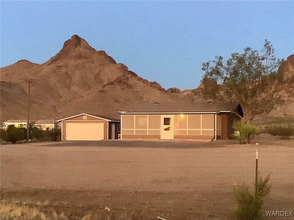 2661 Papago Road Golden Valley, AZ 86413 - Photo 3 of 30 a front view of a house with a yard and garage