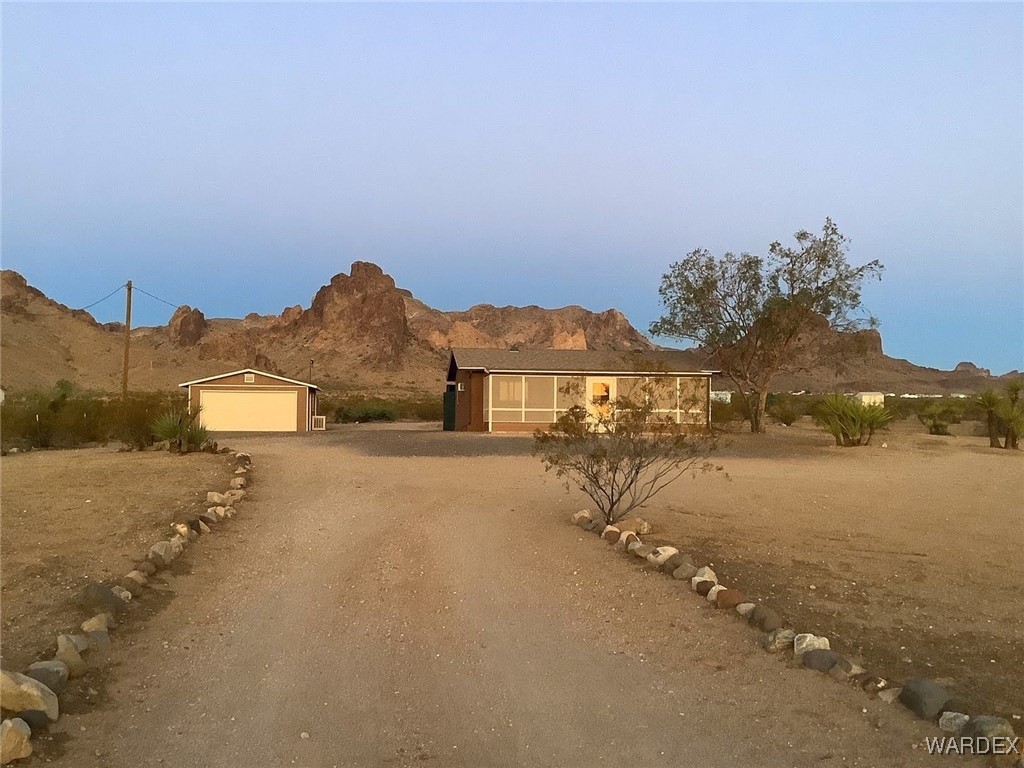 2661 Papago Road Golden Valley, AZ 86413 - Photo 4 of 30 a view of a town with large trees and mountains in the background