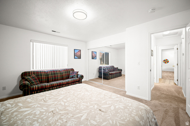 1825 West Mathis Park Place, Unit 46 St. George, UT 84770 - Photo 21 of 45 Bedroom with light carpet and a closet