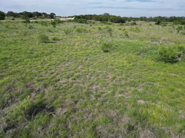 a view of a green field with an ocean view