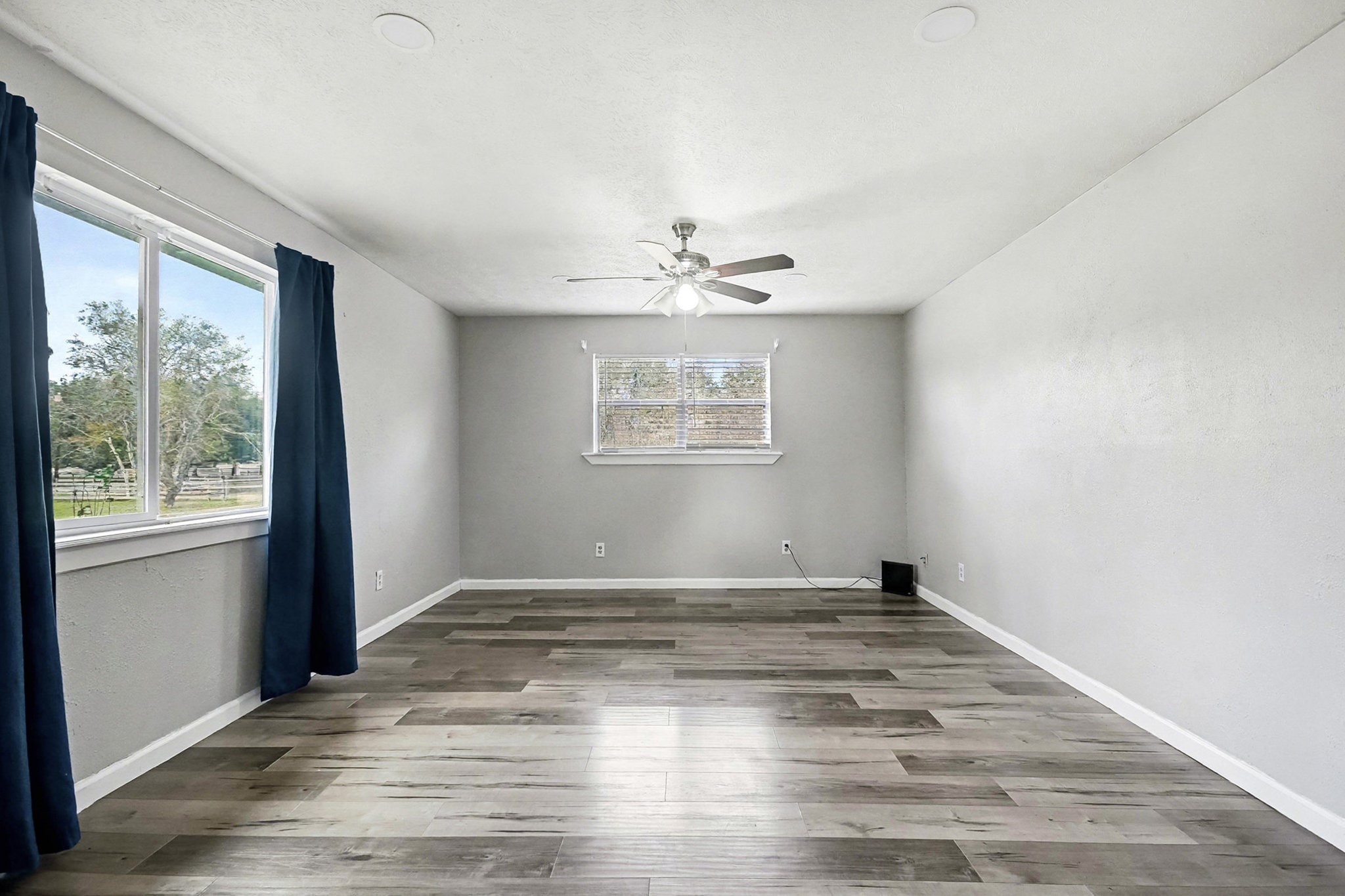 1627 Texas Avenue League City, TX 77573 - Photo 14 of 26 an empty room with wooden floor and windows