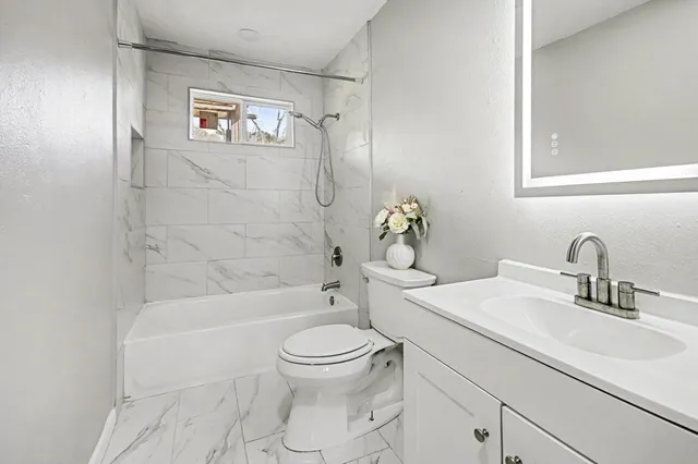 a bathroom with a sink toilet and shower