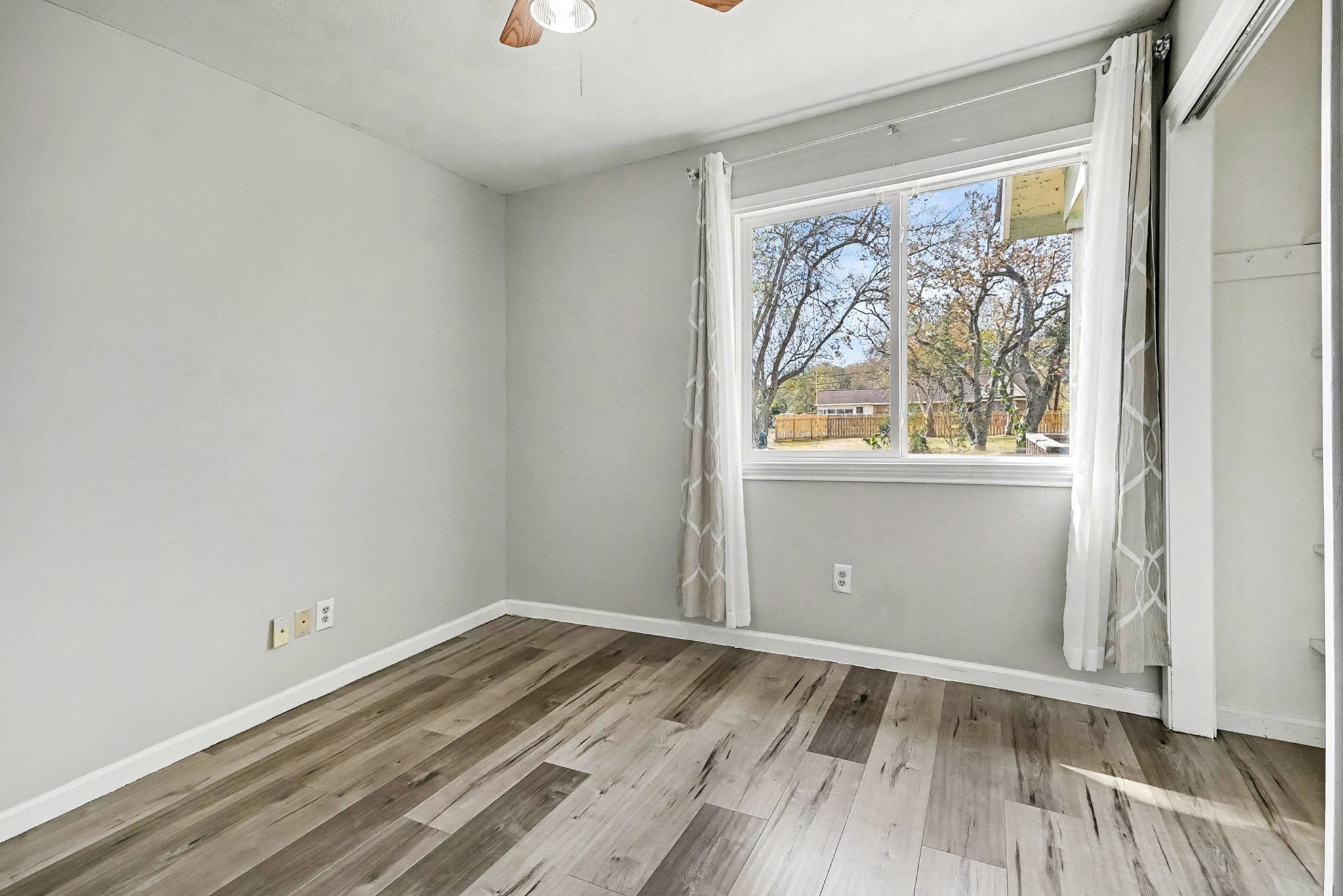 1627 Texas Avenue League City, TX 77573 - Photo 18 of 26 an empty room with wooden floor and windows