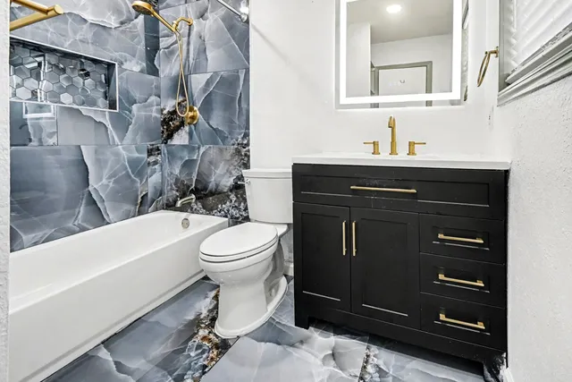 a bathroom with a sink a toilet and bathtub