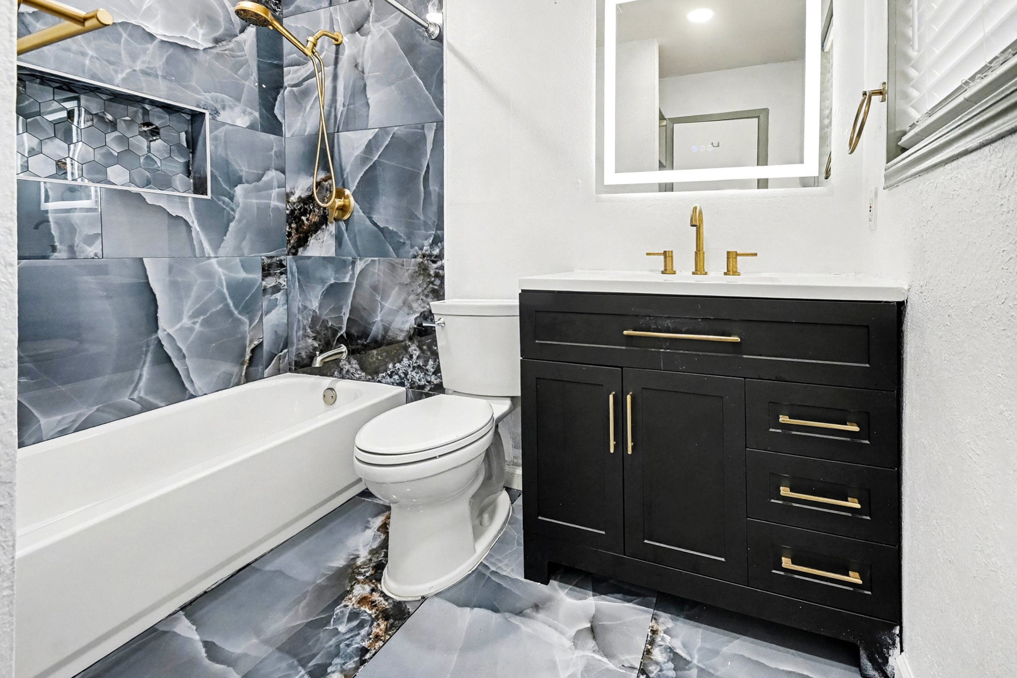 1627 Texas Avenue League City, TX 77573 - Photo 21 of 26 a bathroom with a sink a toilet and bathtub