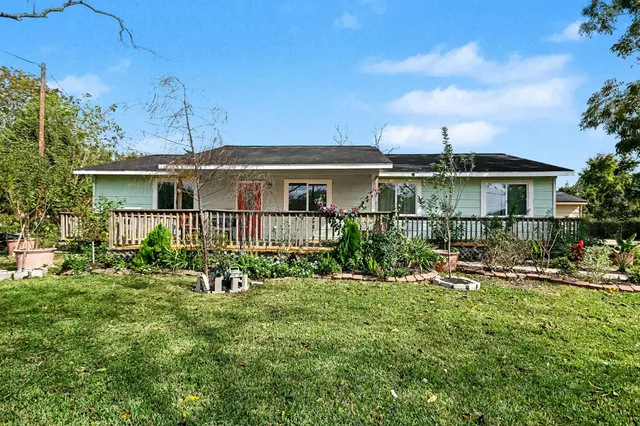 a front view of a house with yard and green space