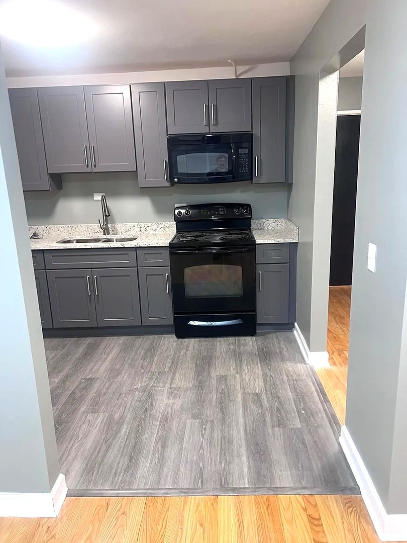 6619 North Sheridan Road, Unit 305 Chicago, IL 60626 - Photo 5 of 10 a kitchen with granite countertop a stove a sink and a refrigerator
