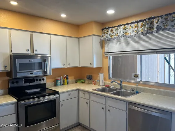 a kitchen with a sink stove and microwave