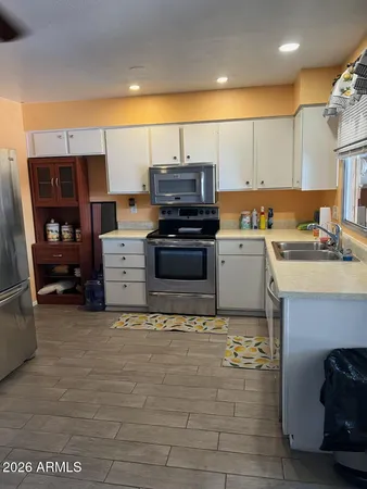 a kitchen with stainless steel appliances granite countertop a stove and a sink
