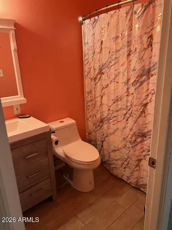 a bathroom with a toilet and shower