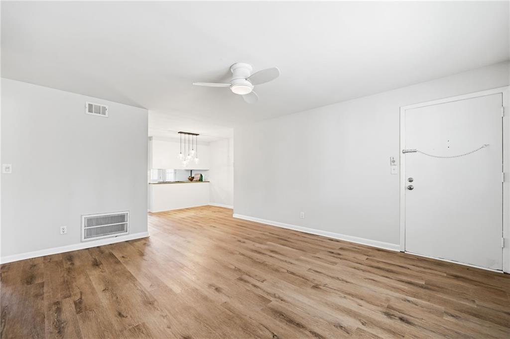 1010 Scott Boulevard, Unit A2 Decatur, GA 30030 - Photo 11 of 23 an empty room with wooden floor and windows