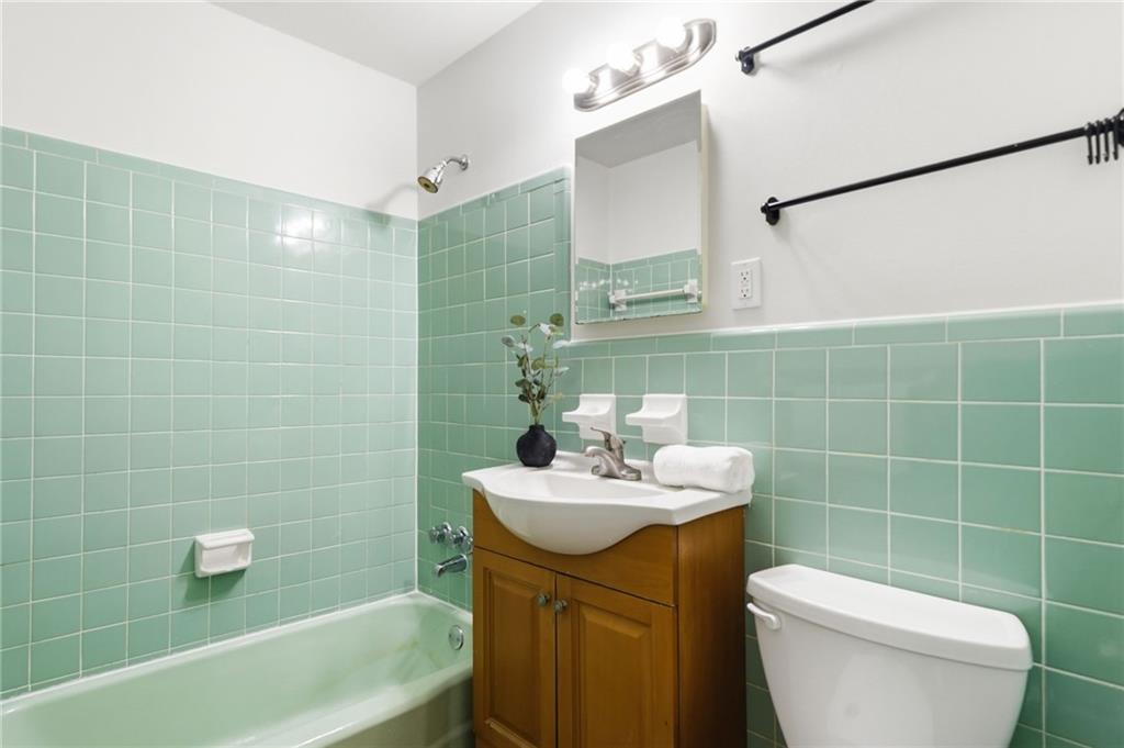 1010 Scott Boulevard, Unit A2 Decatur, GA 30030 - Photo 12 of 23 a bathroom with a sink a toilet and a mirror