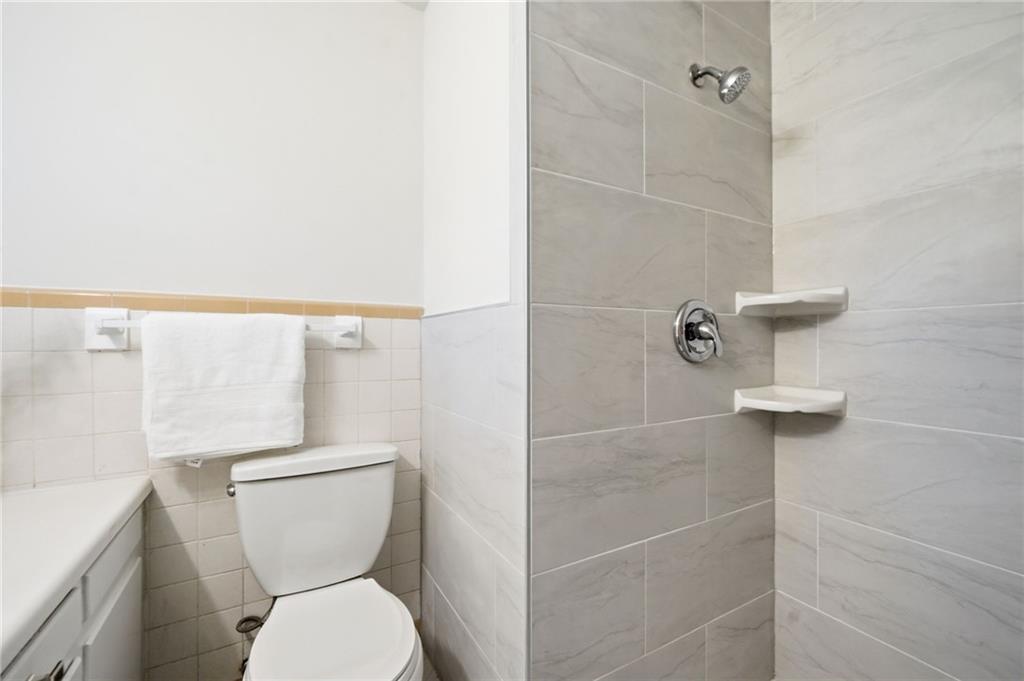 1010 Scott Boulevard, Unit A2 Decatur, GA 30030 - Photo 17 of 23 a white toilet sitting next to a bathroom sink
