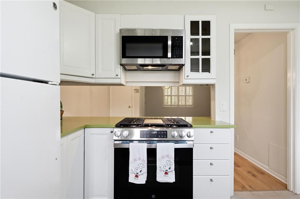 1010 Scott Boulevard, Unit A2 Decatur, GA 30030 - Photo 5 of 23 a kitchen with stainless steel appliances a stove and a microwave