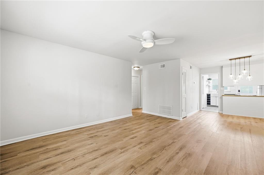 1010 Scott Boulevard, Unit A2 Decatur, GA 30030 - Photo 10 of 23 a view of a kitchen with wooden floor and a ceiling fan