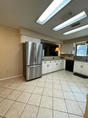 a kitchen with stainless steel appliances a refrigerator sink and microwave
