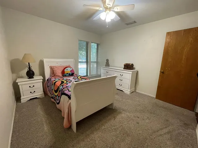 a bed room with a bed and a chandelier