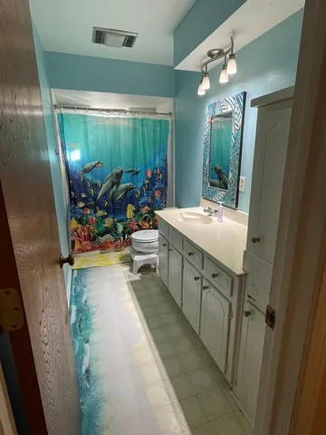 a bathroom with sink a mirror and shower