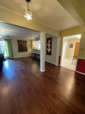 a view of a livingroom with furniture wooden floor and a ceiling fan