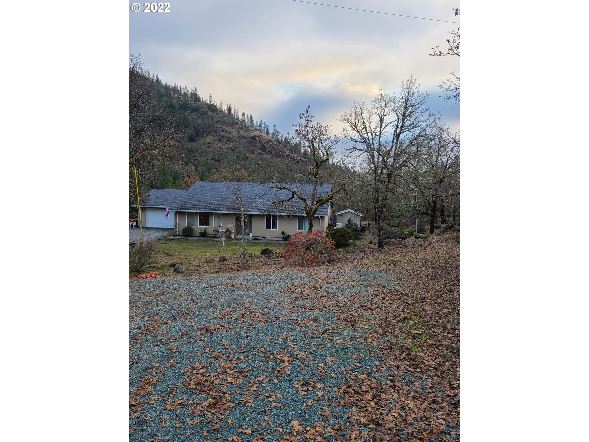 793 Jumpoff Joe Creek Road Grants Pass, OR 97526 - Photo 1 of 12 a view of a house with a yard and sitting area